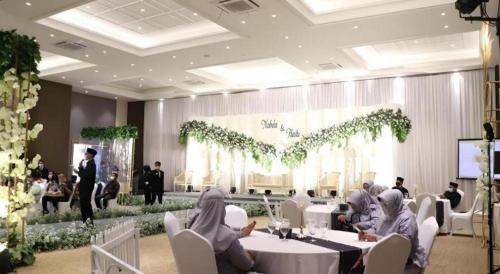 a group of people sitting at tables in a room at Fitra Hotel Majalengka in Majalengka