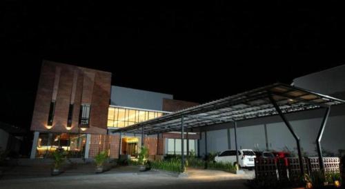 a building with a car parked in front of it at Fitra Hotel Majalengka in Majalengka