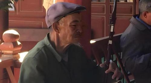 a man with a hat and a police officer at Lijiang Peach Hostel in Lijiang