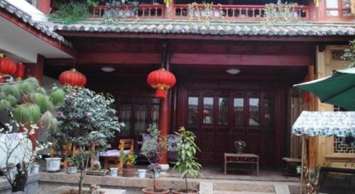 a building with red lanterns on the front of it at Lijiang Peach Hostel in Lijiang