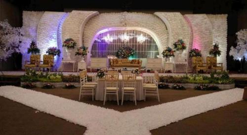 a banquet hall with tables and chairs in a building at Ratu Hotel Serang in Serang