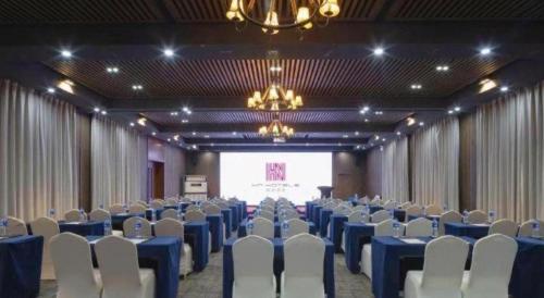 a banquet hall with blue tables and white chairs at NH Shijiazhuang Financial Center in Shijiazhuang