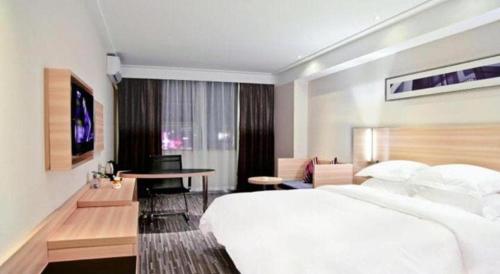 Letto o letti in una camera di City Comfort Inn Nanning Railway Station