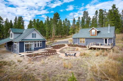 a blue house with a porch and a yard at Silver Lining Circle home in Fraser