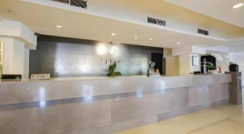 a lobby with a dance floor in a building at Kenari Tower Hotel in Makassar