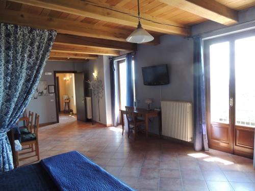 a living room with a bed and a dining room at Da Fabiana in Bossolasco