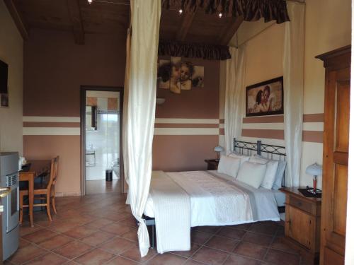a bedroom with a bed and a table and chairs at Da Fabiana in Bossolasco