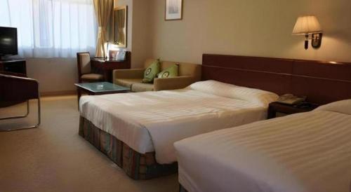 Postel nebo postele na pokoji v ubytování West Hotel