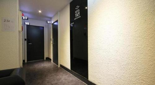 a hallway with two elevators in a building at Hotel Yam ANDONG in Andong