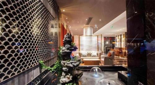 a lobby with a christmas tree in the middle of a room at Jinjiang Metropolo Hotel Nanjing Confucius Temple Branch in Nanjing