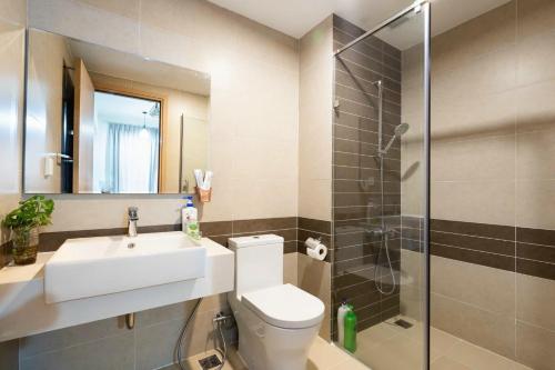 a bathroom with a toilet and a sink and a shower at Rivergate Apartment Central in HCM City in Ho Chi Minh City