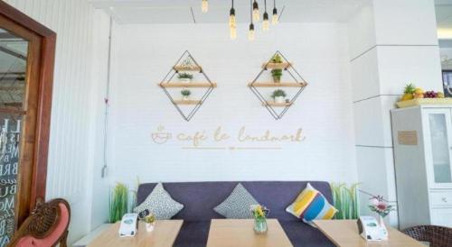 a dining room with a table and a bench and a wall at LANDMARK NAKHONPHANOM HOTEL in Nakhon Phanom