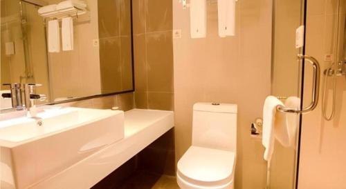 a bathroom with a white toilet and a sink at JTOUR Inn Guilin Two Rivers and Four Lakes Walmart in Guilin
