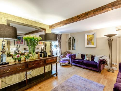 a living room with purple furniture and a purple couch at 4 Bed in Middleham 83260 in Middleham