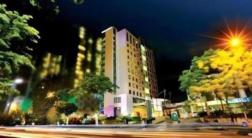 a building on a city street at night at PARK HOTEL Cawang Jakarta in Jakarta