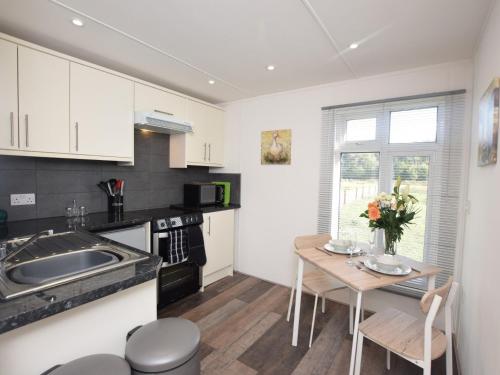 a kitchen with a table and a small kitchen with a sink at 1 Bed in Thetford 76493 in East Harling