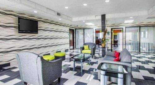 a waiting room with chairs and a tv in a building at Quality Inn Prattville I-65 in Prattville