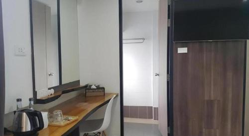 a bathroom with a desk with a mirror and a sink at Veethara boutique hotel in Udon Thani