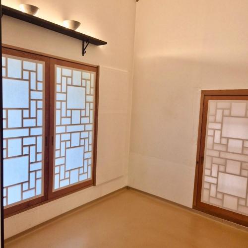 a room with two windows and a door at Andong GyeongHamjeong in Andong
