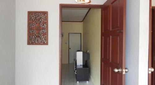 a hallway with a door leading to a room at Jinta Hotel Nathon Beach in Chaweng