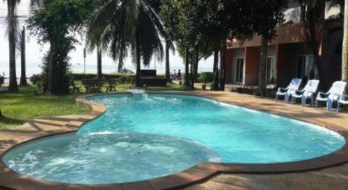 a large swimming pool with a fountain in a yard at Jinta Hotel Nathon Beach in Chaweng