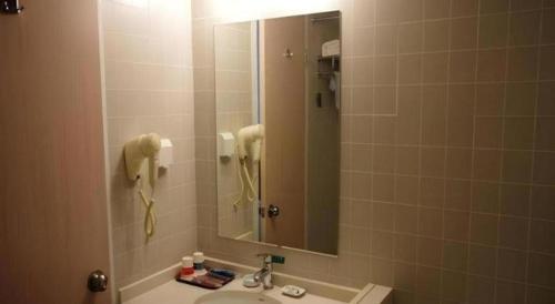 a bathroom with a sink and a mirror at Jinjiang Inn Pingyao Branch in Pingyao
