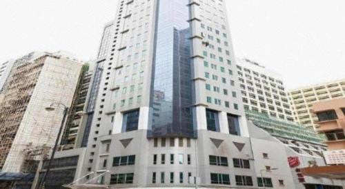a tall building in the middle of a city at Metro Winner Hotel in Hong Kong