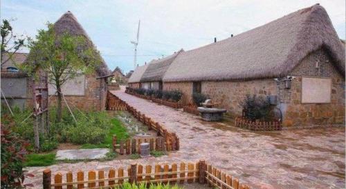 a row of brick buildings with at Atour Hotel Weihai Shidao in Dongshan
