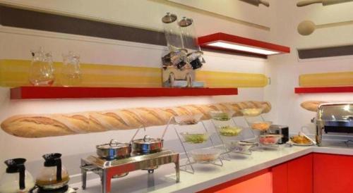a kitchen with a counter with some food on it at Ibis Harbin Normal University in Harbin