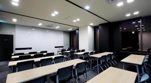 a classroom with desks and chairs and a whiteboard at Kintex by K-tree in Goyang