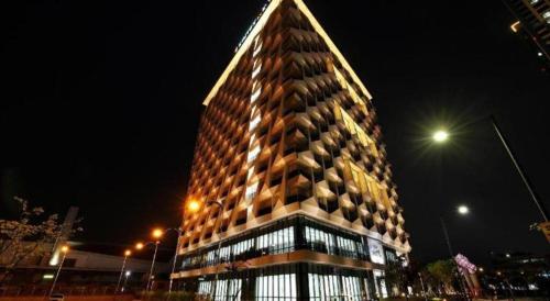 a tall building at night with at Kintex by K-tree in Goyang