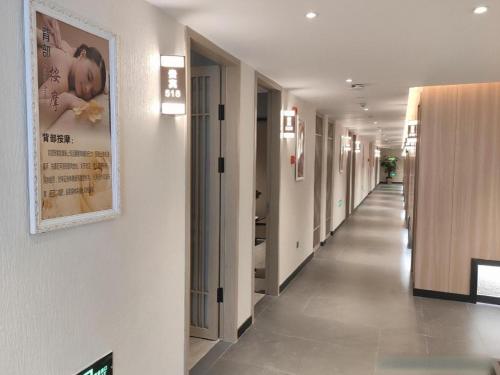 a hallway of a hospital with a poster on the wall at Taiyi International Hotel in Wenzhou