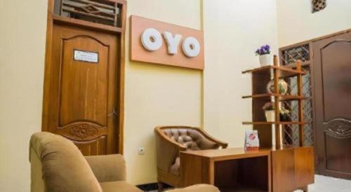 a living room with a couch and a chair at OYO 643 Al Thalib 8 Syariah in Malang