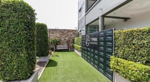a garden with a sign in front of a building at OYO 75305 T Park Pak Chong in Mu Si