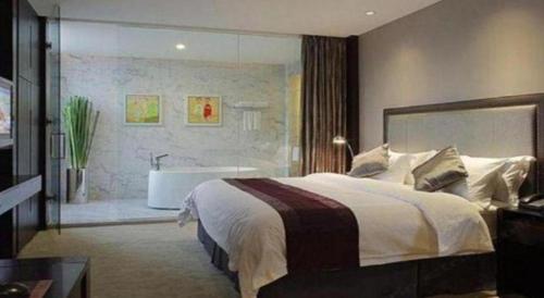 a bedroom with a large bed and a bath tub at New Century Manju Hotel Shanghai New International Expo Center in Shanghai