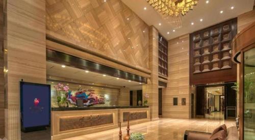 a lobby of a building with a tv in it at New Century Manju Hotel Shanghai New International Expo Center in Shanghai