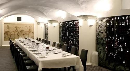 a long table in a room with wine bottles at Fifteen Beacon Hotel in Boston