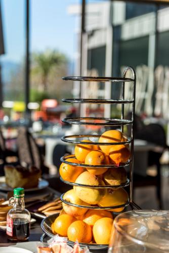 a pile of oranges on plates on a table at Best Western Aquakub in Aix-les-Bains