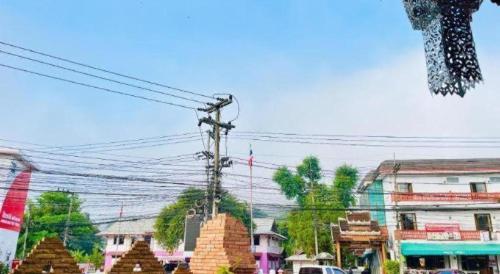 a view of a city street with trees and buildings at Ngamta Hotel in Mae Hong Son