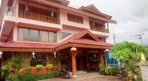 a large building with a balcony on top of it at Ngamta Hotel in Mae Hong Son