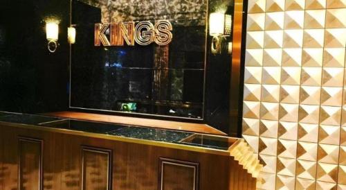 a counter with a kings sign on a wall at King's Hotel in Hong Kong
