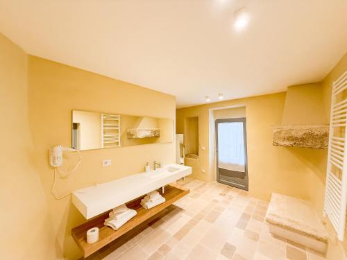 a bathroom with a sink and a mirror at Borgo Cucumo by MONHOLIDAY in Castellana Grotte