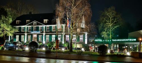 a building with lights in front of it at night at Parkhotel FRITZ am Brunnen in Schwelm