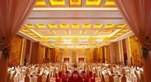 a large banquet hall with a large group of people at Gaosu New Century Hotel International Anhui in Hefei