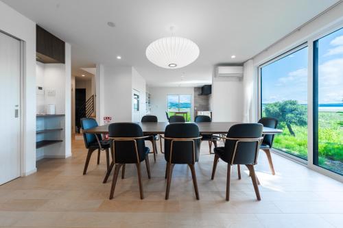 a dining room with a table and chairs at Yugen Retreats Furano in Kami-furano