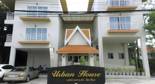 a white house with a sign in front of it at Urban House 195 in Chiang Mai