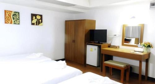 a hotel room with a desk and a bed and a computer at Urban House 195 in Chiang Mai