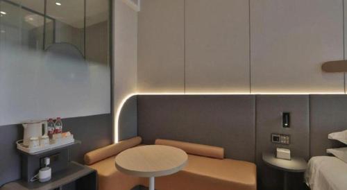 a small room with a table and a bed at Jinjiang Inn Changchun Xi An Avenue Branch in Changchun
