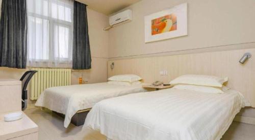 Letto o letti in una camera di Jinjiang Inn Tai'an Taishan Railway Station