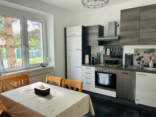 a kitchen with a wooden table and a table and a tableablish at Guesthouse Tulln in Tulln